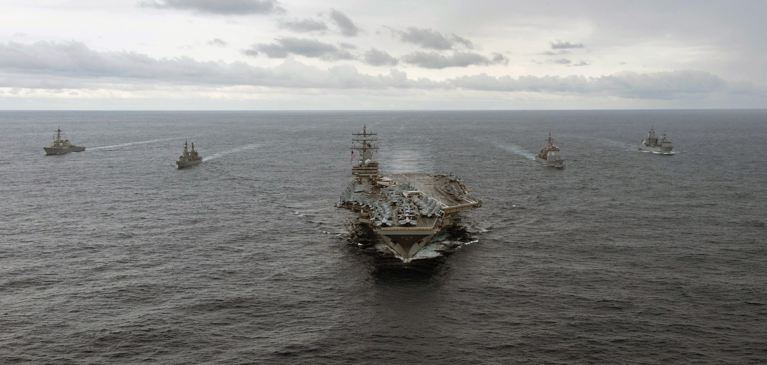 Forward-deployed aircraft carrier USSRonald Reagan steams in formation withguided-missile destroyer USS Milius, JapanMaritime Self-Defense Force ship JS Setogiri,guided-missile cruiser USS Chancellorsville,and Royal Australian Navy supply ship HMASStalwart, in Philippine Sea, November 20,2022 (U.S. Navy/Louis Thompson Staats IV)